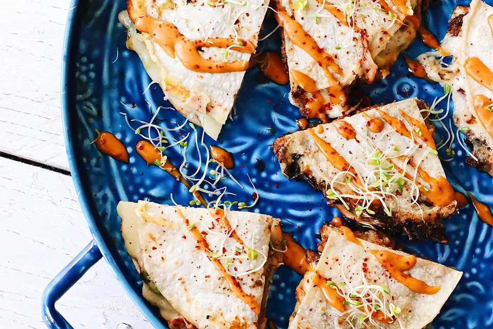 Beef Quesadilla For Lunch Image of beef quesadilla served with sauce on a ble platter