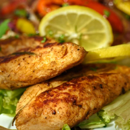 Close up image of Gluten Free Grilled Lemon Pepper Chicken served with slice of lemon