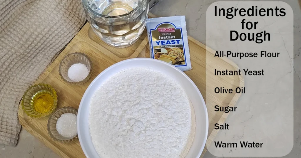 Ingredients for homemade pizza dough placed on a light brown wooden board with a napkin in the background