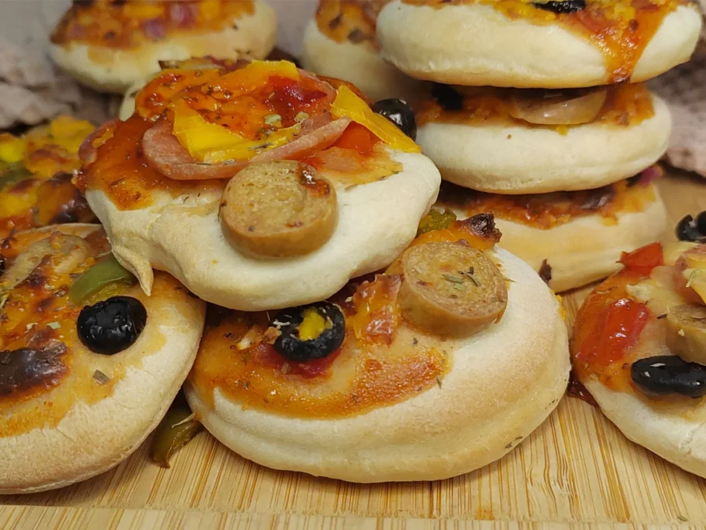 Mini Pizzas with black olives sausages and pepperoni made with homemade dough