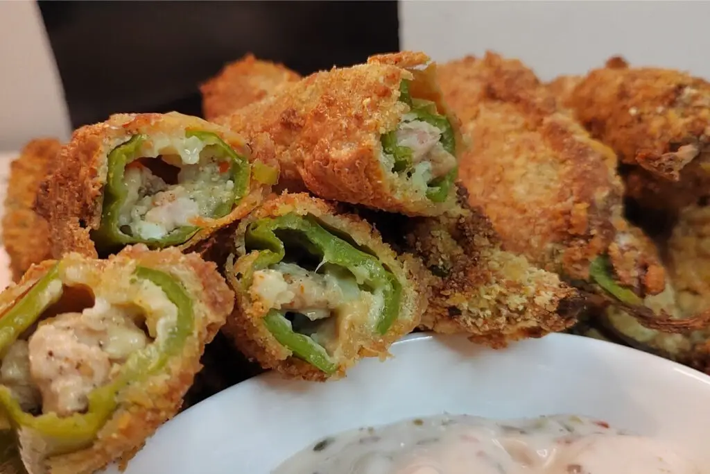 Close up image of peri bites filled with cheesy chicken filling, served with garlic mayo sauce