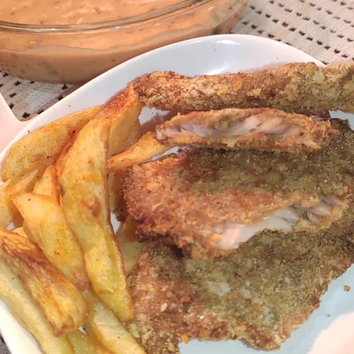 Closeup top view image of air fried fish and chips