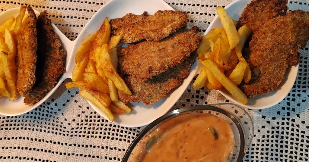 Top View of Perfectly air fried fish and chips served with spicy garlic mayo sauce